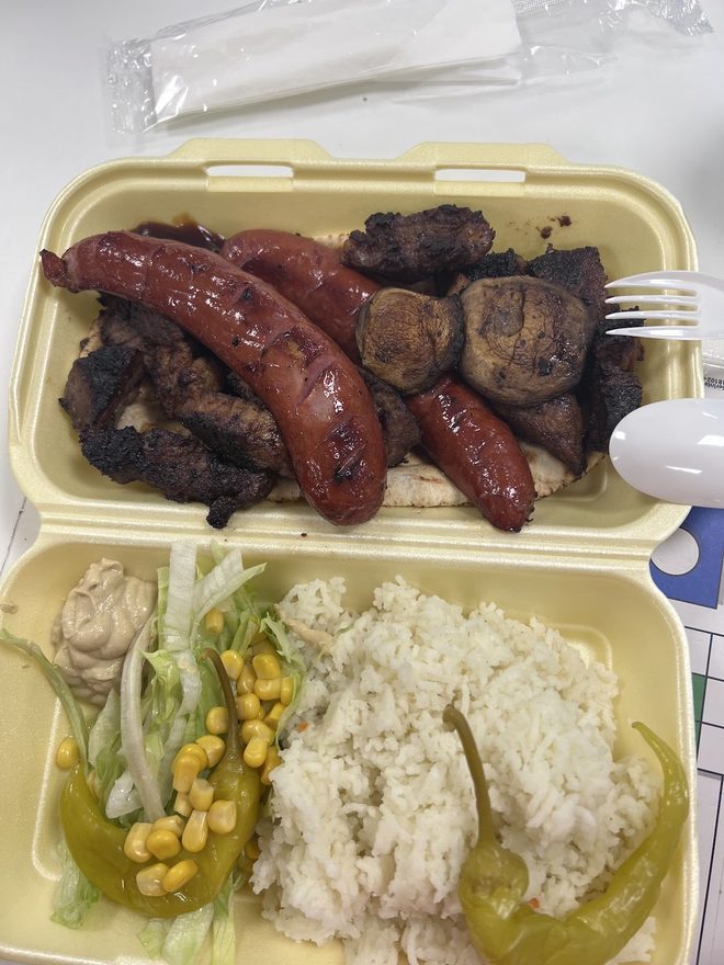 Grilled meats with rice and salad in a two-compartment box